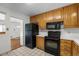 Functional kitchen with wooden cabinets and black appliances offering a practical cooking space at 920 Emerson Cir, Northglenn, CO 80233
