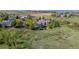 Aerial shot of a home and neighborhood with a large, open field in the background at 9728 Ashleigh Ln, Highlands Ranch, CO 80126