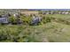 Wide aerial shot showcasing a home, its landscaping, and surrounding community with scenic open space and mountain views at 9728 Ashleigh Ln, Highlands Ranch, CO 80126