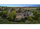 Beautiful aerial view of home with mature trees, landscaping and an expansive yard surrounded by a wooden fence at 9728 Ashleigh Ln, Highlands Ranch, CO 80126