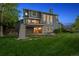 Back exterior showcasing a deck, a covered patio, and a beautifully landscaped backyard at 9728 Ashleigh Ln, Highlands Ranch, CO 80126