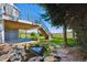 Backyard featuring a pond, beautiful stone, stairs to the deck, and greenery at 9728 Ashleigh Ln, Highlands Ranch, CO 80126