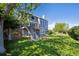 Two-story home featuring a large, green backyard with a balcony and stairs at 9728 Ashleigh Ln, Highlands Ranch, CO 80126