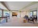 Open concept basement with a ping pong table, seating area, and storage at 9728 Ashleigh Ln, Highlands Ranch, CO 80126