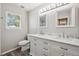 Bathroom with dual sinks, modern fixtures, and natural light from the window at 9728 Ashleigh Ln, Highlands Ranch, CO 80126