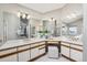 Spacious bathroom with dual sinks, vanity area, large mirrors, and modern fixtures at 9728 Ashleigh Ln, Highlands Ranch, CO 80126