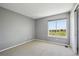 Neutral bedroom with a large window, offering pleasant views of the neighborhood at 9728 Ashleigh Ln, Highlands Ranch, CO 80126