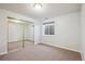 Bedroom with natural light, carpeted floors, and a closet with mirrored doors at 9728 Ashleigh Ln, Highlands Ranch, CO 80126