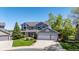 Charming two-story home featuring a three-car garage, well-manicured lawn and mature landscaping at 9728 Ashleigh Ln, Highlands Ranch, CO 80126