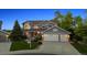 Charming two-story home with a well-manicured lawn, a three-car garage, and beautiful landscaping at 9728 Ashleigh Ln, Highlands Ranch, CO 80126