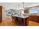 Spacious kitchen with wood floors, island with seating, granite countertops, and stainless steel appliances at 9728 Ashleigh Ln, Highlands Ranch, CO 80126