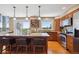 Bright kitchen featuring a large island with bar seating, wood cabinets, stainless steel appliances, and a view at 9728 Ashleigh Ln, Highlands Ranch, CO 80126