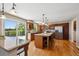 Open kitchen featuring wood cabinets, stainless steel appliances, granite countertops, island with bar seating, and a deck at 9728 Ashleigh Ln, Highlands Ranch, CO 80126
