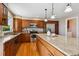 Open kitchen featuring granite countertops, stainless steel appliances, wood cabinets, and a large center island at 9728 Ashleigh Ln, Highlands Ranch, CO 80126
