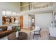 Bright living room with hardwood floors, an open staircase, and views into the kitchen at 9728 Ashleigh Ln, Highlands Ranch, CO 80126