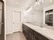 Bright bathroom featuring a dual sink vanity with a stone counter, tiled floor, and a shower at 10570 Worchester Dr, Commerce City, CO 80022