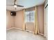 Bedroom featuring a ceiling fan, light-colored walls, and a window with curtains at 10570 Worchester Dr, Commerce City, CO 80022