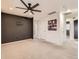 Bedroom boasting a ceiling fan, dark accent wall, and neutral carpet at 10570 Worchester Dr, Commerce City, CO 80022