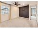 Bedroom featuring a ceiling fan, dark accent wall, and neutral carpet at 10570 Worchester Dr, Commerce City, CO 80022
