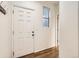 Entryway featuring a white door, hardwood floors, and a window at 10570 Worchester Dr, Commerce City, CO 80022