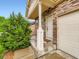 Close up of a charming front porch featuring a white door and stone pillar at 10570 Worchester Dr, Commerce City, CO 80022