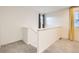 Hallway featuring neutral carpet, white walls, and a window at 10570 Worchester Dr, Commerce City, CO 80022