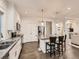 Bright kitchen featuring granite counters, stainless appliances, white cabinets, and hardwood floors at 10570 Worchester Dr, Commerce City, CO 80022