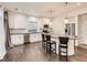 Bright modern kitchen featuring white cabinets, a large island, and bar stool seating at 10570 Worchester Dr, Commerce City, CO 80022