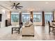 Bright living room with a modern ceiling fan and three large windows and a comfortable seating arrangement at 10570 Worchester Dr, Commerce City, CO 80022