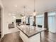 Open-concept space showing the living room seamlessly connected to the dining area with bar stool seating at 10570 Worchester Dr, Commerce City, CO 80022