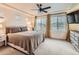 Main bedroom featuring neutral carpet, recessed lighting, a ceiling fan, and large windows at 10570 Worchester Dr, Commerce City, CO 80022