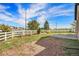 Wide shot of the spacious backyard with grass, and a white fence, perfect for entertaining or relaxing at 7998 Faith Ct, Frederick, CO 80530
