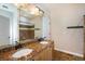 Bathroom with double vanity, granite countertops, tile backsplash, and dark fixtures at 7998 Faith Ct, Frederick, CO 80530