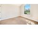 Bright bedroom with neutral carpet and a large window overlooking the yard at 7998 Faith Ct, Frederick, CO 80530