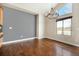 Dining room with hardwood floors, a chandelier, and a large window, creating an inviting space at 7998 Faith Ct, Frederick, CO 80530