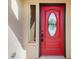 Close-up of a vibrant red front door with decorative glass and black hardware at 7998 Faith Ct, Frederick, CO 80530