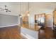 Open concept kitchen with granite island, stainless steel appliances, and hardwood floors, perfect for cooking at 7998 Faith Ct, Frederick, CO 80530