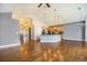 Spacious living room with hardwood floors, view to the open kitchen at 7998 Faith Ct, Frederick, CO 80530