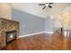 Bright living room features stone fireplace, hardwood floors, and open entryway at 7998 Faith Ct, Frederick, CO 80530