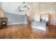 Spacious living room with hardwood floors, stone fireplace, and a open kitchen at 7998 Faith Ct, Frederick, CO 80530