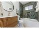 Modern bathroom with a walk-in shower, bathtub, and stylish vanity at 3307 Teller St, Wheat Ridge, CO 80033