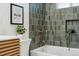 Updated bathroom features a soaking tub and green tile shower at 3307 Teller St, Wheat Ridge, CO 80033