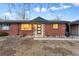 Charming ranch-style home with brick facade and updated entryway at 3307 Teller St, Wheat Ridge, CO 80033