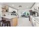 Updated kitchen featuring white cabinets and a large island at 3307 Teller St, Wheat Ridge, CO 80033