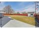 A large, fenced backyard with a storage shed, offering ample space and privacy at 3165 W 63Rd Ave, Denver, CO 80221