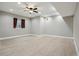 Finished basement with light flooring, a ceiling fan and a window at 3165 W 63Rd Ave, Denver, CO 80221