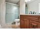 Bathroom featuring a glass door shower, wood vanity and a neutral color scheme at 3165 W 63Rd Ave, Denver, CO 80221