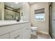 Bathroom with a double vanity, toilet and a glass-enclosed shower at 3165 W 63Rd Ave, Denver, CO 80221