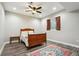A cozy bedroom featuring wood floors, a classic bed frame, and a ceiling fan at 3165 W 63Rd Ave, Denver, CO 80221