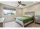 Inviting bedroom with a ceiling fan, window, and light-colored bed frame at 3165 W 63Rd Ave, Denver, CO 80221